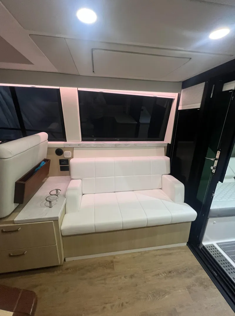 Slide: The Image of Interior of 2023 Regal 38 XO yacht with modern seating and ambient lighting. - 11