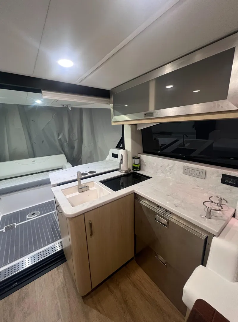 Slide: The Image of Modern kitchen area in 2023 Regal 38 XO yacht with sleek cabinetry and appliances. - 14