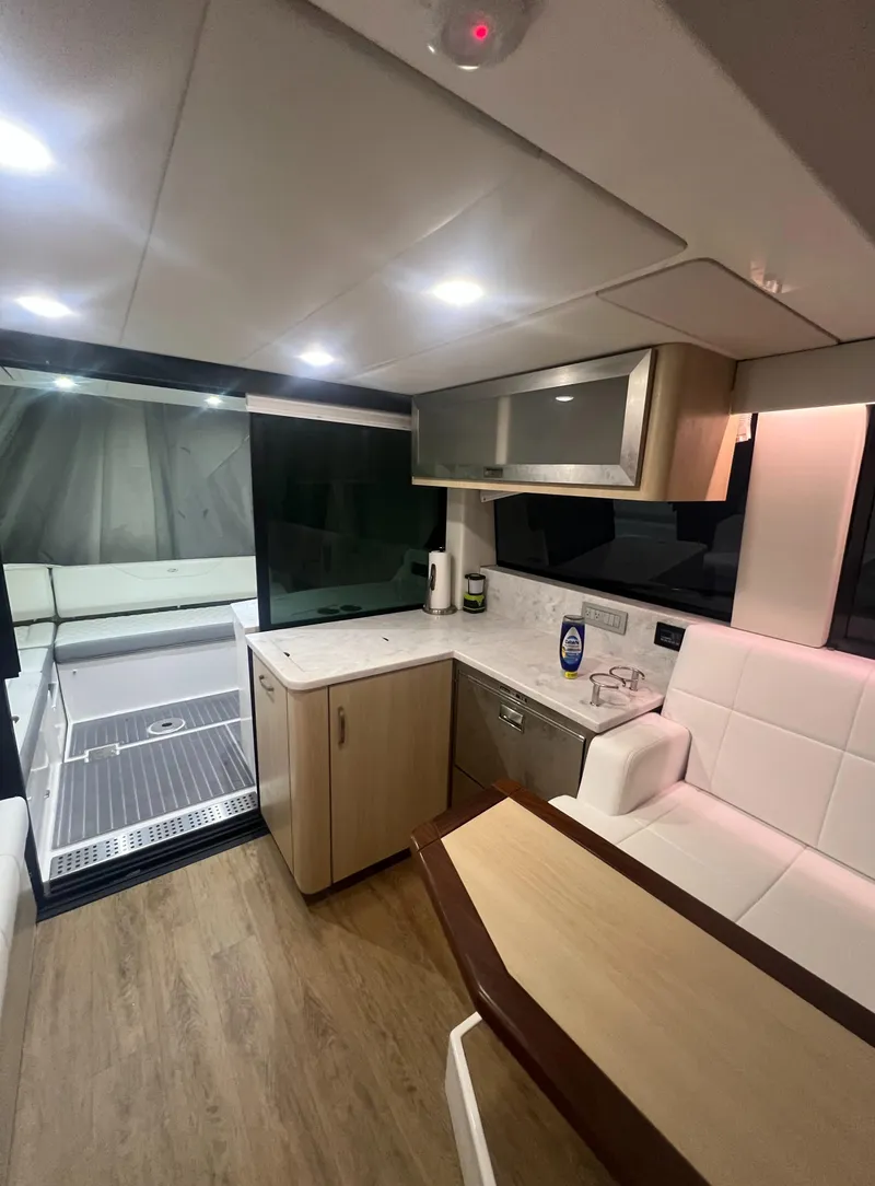 Slide: The Image of Luxurious interior of 2023 Regal 38 XO yacht with modern kitchen and seating area. - 17