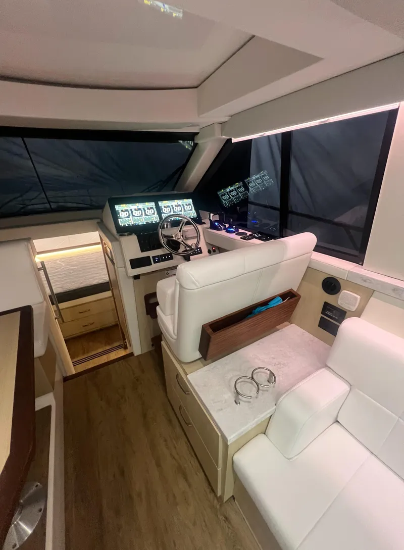Slide: The Image of Luxurious 2023 Regal 38 XO yacht interior with modern helm and plush seating. - 18