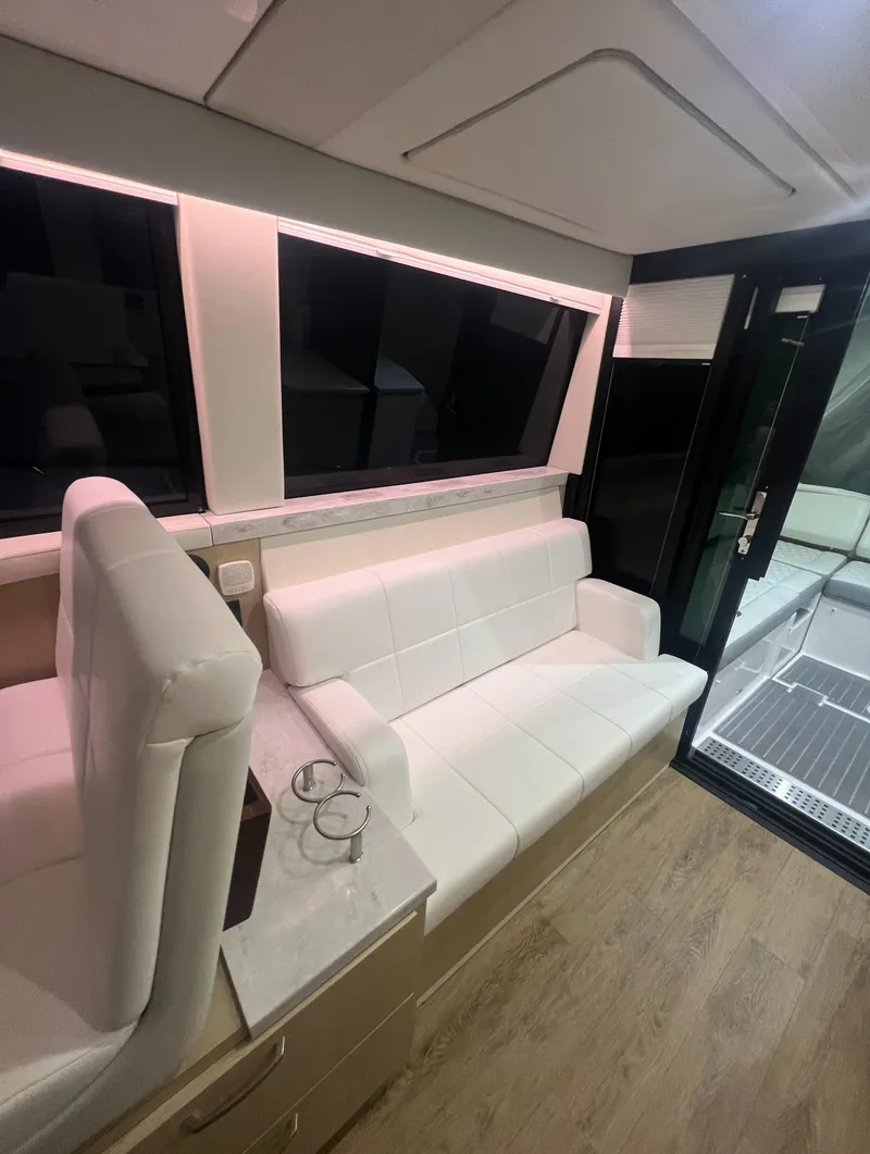 Slide: The Image of Luxurious interior of 2023 Regal 38 XO yacht with white seating and modern design. - 19