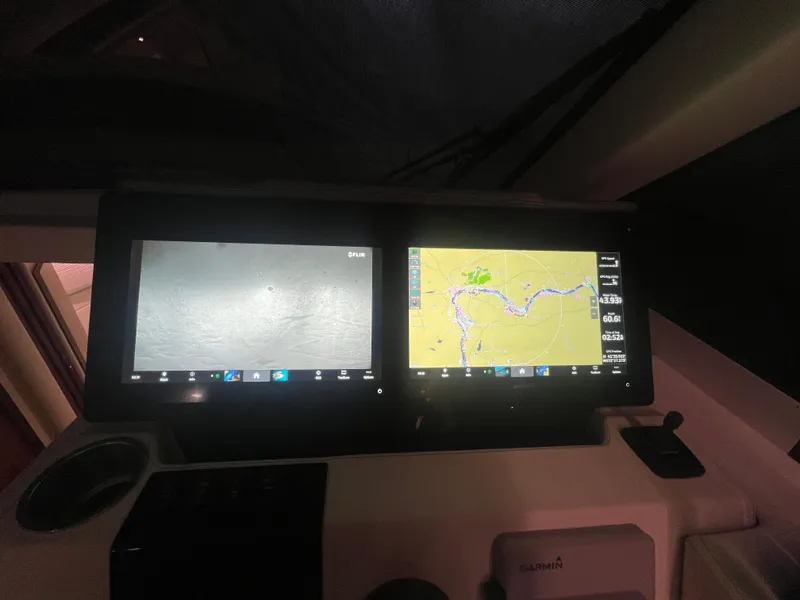 Slide: The Image of 2023 Regal 38 XO boat navigation screens displaying maps and sonar. - 23