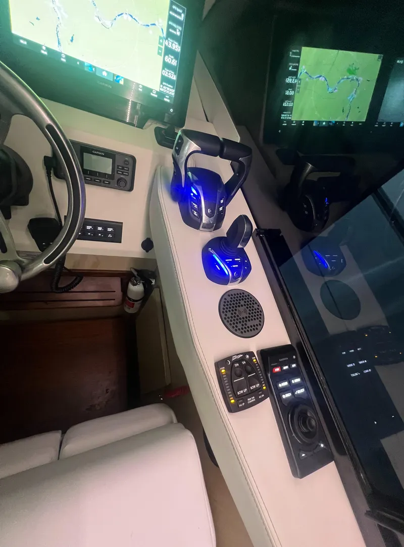 Slide: The Image of 2023 Regal 38 XO helm with advanced navigation and control systems. - 24