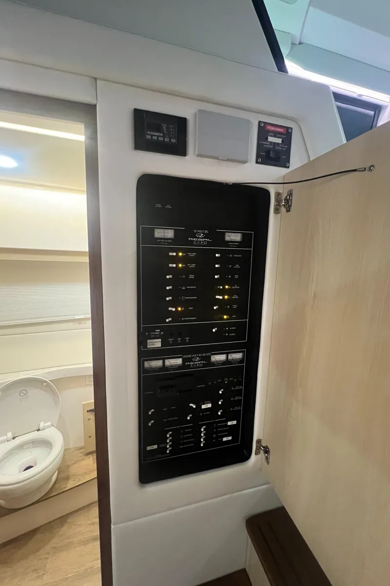 Slide: The Image of 2023 Regal 38 XO yacht interior control panel and bathroom view. - 26