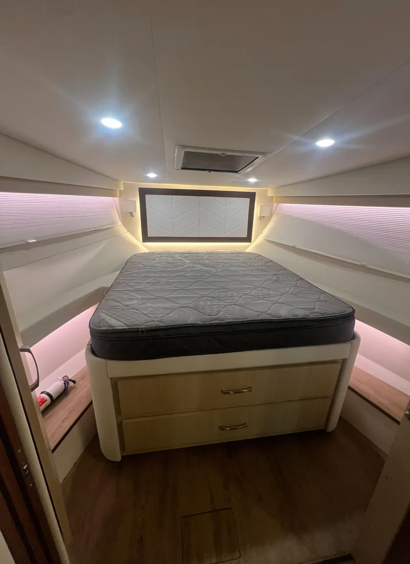 Slide: The Image of Luxurious cabin interior of 2023 Regal 38 XO yacht with cozy bed and ambient lighting. - 28