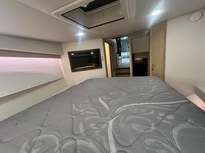 Slide: The Image of 2023 Regal 38 XO yacht interior cabin with bed and modern design. - 30
