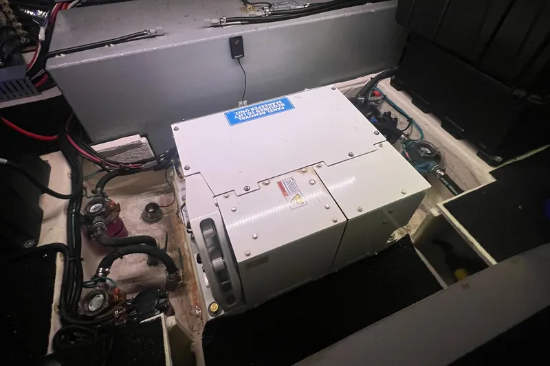 Slide: The Image of Engine compartment of 2023 Regal 38 XO boat, showcasing generator and wiring. - 38