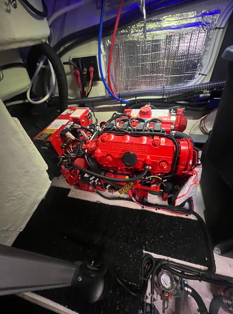 Slide: The Image of 2023 Regal 38 XO engine room with red diesel engine and wiring. - 39
