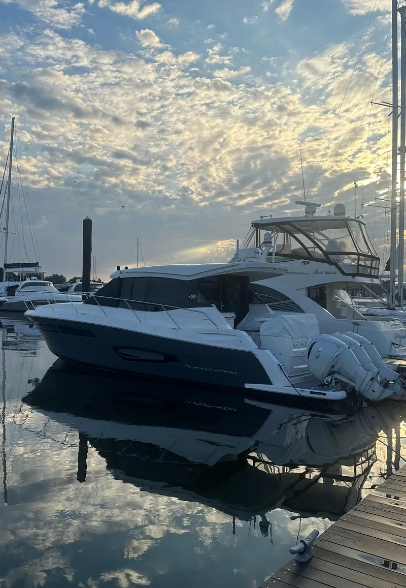 Slide: The Image of 2023 Regal 38 XO yacht docked at marina during sunset. - 4