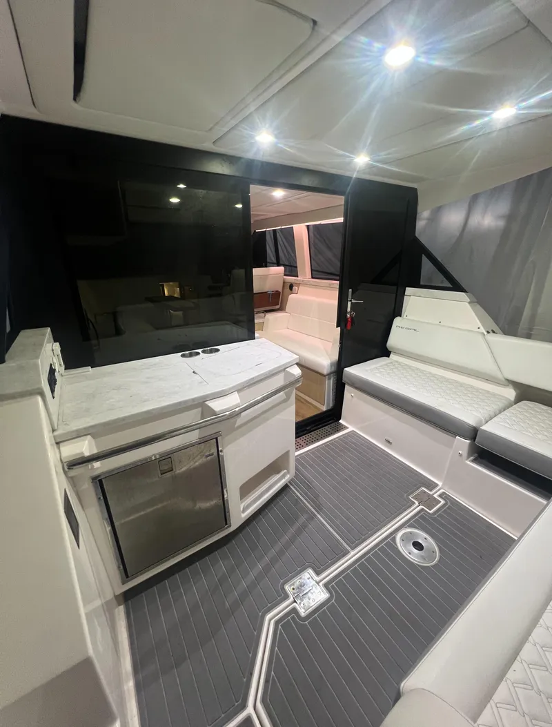 Slide: The Image of Luxurious interior of 2023 Regal 38 XO yacht with modern seating and kitchenette. - 5