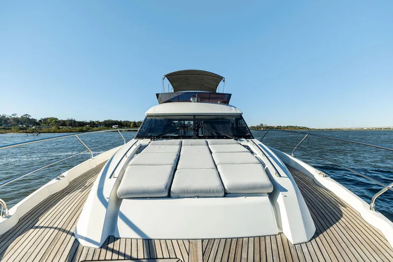 Slide: The Image of 2019 Prestige 520 Fly yacht with sunbathing area on deck, cruising on open water. - 20