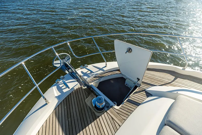 Slide: The Image of Prestige 520 Fly 2019 yacht bow with open anchor hatch on water. - 21