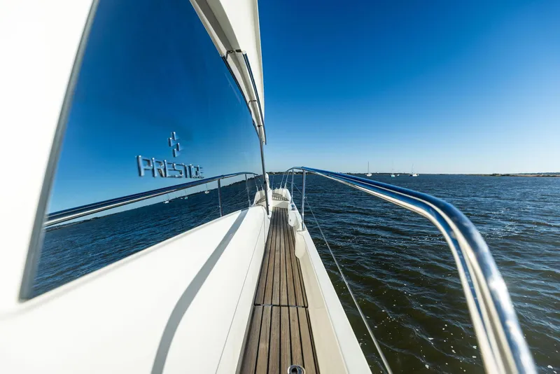 Slide: The Image of Prestige 520 Fly yacht, 2019 model, cruising on open water under clear blue sky. - 23