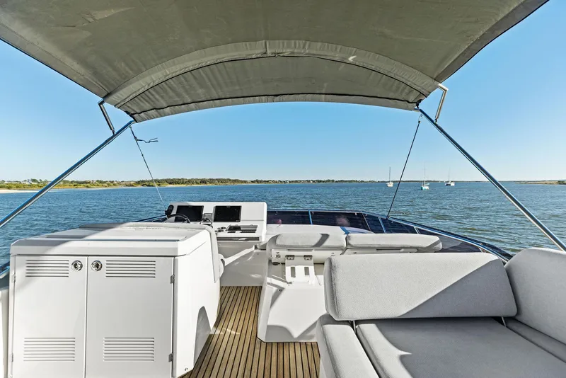 Slide: The Image of Prestige 520 Fly 2019 yacht flybridge with seating, ocean view, and canopy. - 24