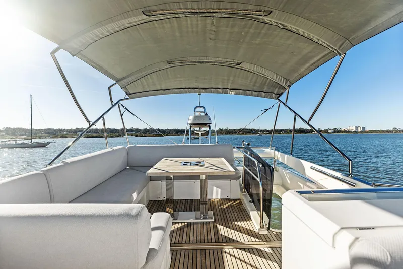Slide: The Image of Luxurious 2019 Prestige 520 Fly yacht with spacious deck and seating area on calm waters. - 29