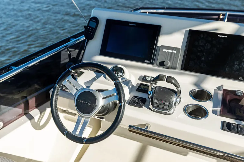 Slide: The Image of Prestige 520 Fly 2019 yacht helm with modern navigation equipment and steering wheel. - 33