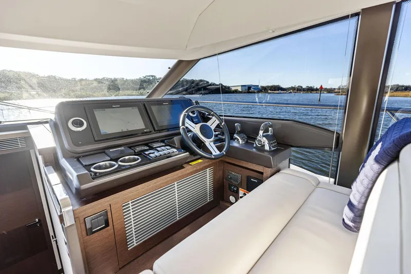 Slide: The Image of Interior helm of 2019 Prestige 520 Fly yacht with modern controls and panoramic view. - 49
