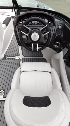 Slide: The Image of 2025 Monterey 224FS boat interior with sleek steering wheel and luxurious seating. - 7