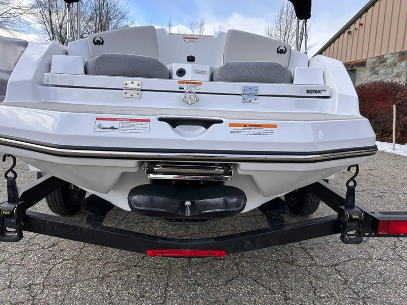 Slide: The Image of 2025 Scarab 165 SE boat on trailer, rear view, white exterior. - 12