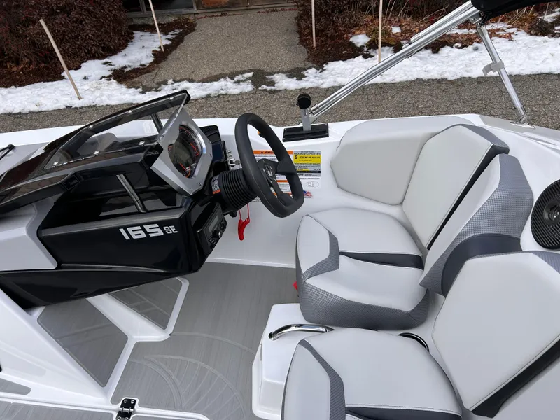 Slide: The Image of 2025 Scarab 165 SE boat interior with modern dashboard and seating. - 17