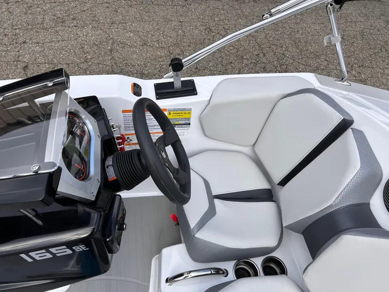 Slide: The Image of 2025 Scarab 165 SE boat interior with steering wheel and seating. - 18