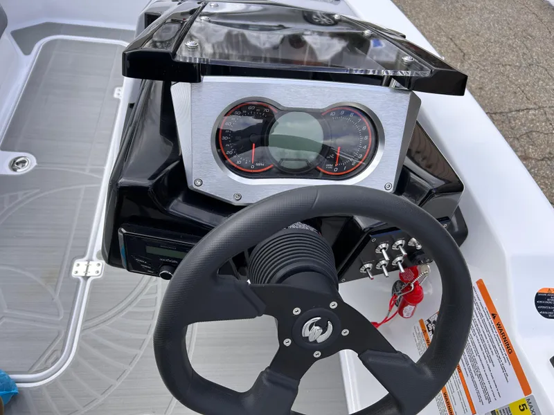 Slide: The Image of 2025 Scarab 165 SE boat dashboard with steering wheel and instrument panel. - 19
