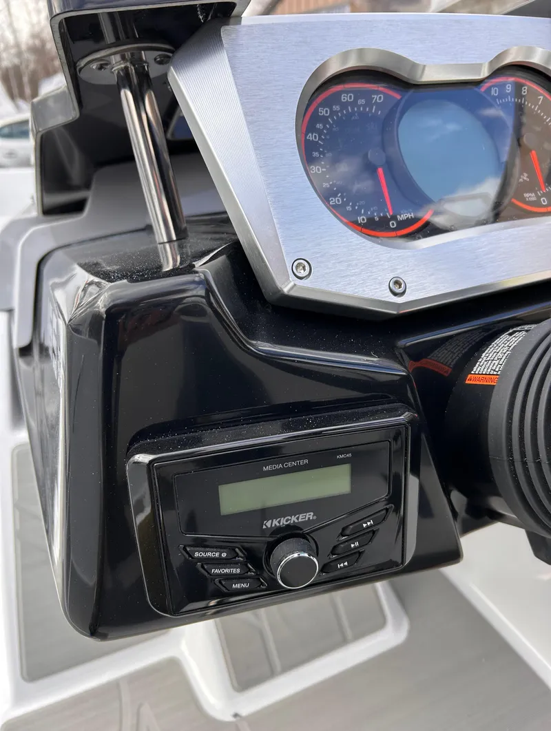 Slide: The Image of 2025 Scarab 165 SE dashboard with Kicker audio system and speedometer. - 21