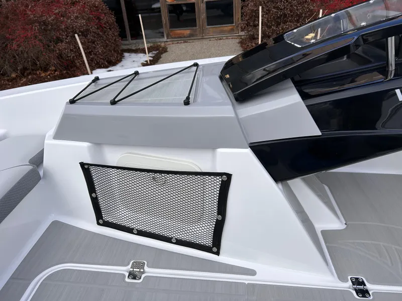 Slide: The Image of 2025 Scarab 165 SE boat interior with sleek design and storage netting. - 24