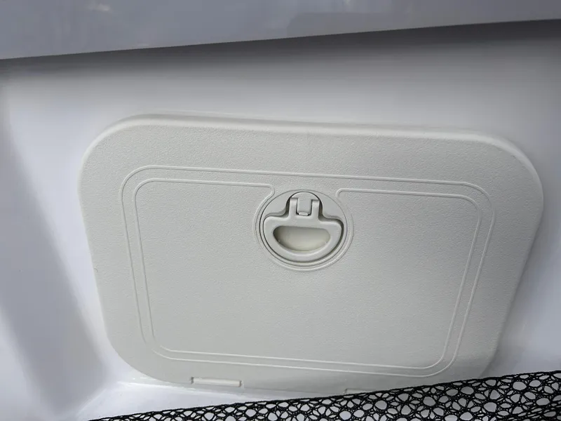 Slide: The Image of 2025 Scarab 165 SE storage compartment with latch, white finish. - 26
