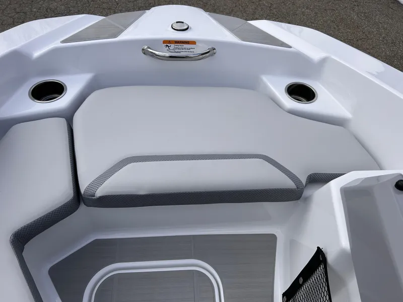 Slide: The Image of 2025 Scarab 165 SE boat interior with cushioned seating and cup holders. - 29