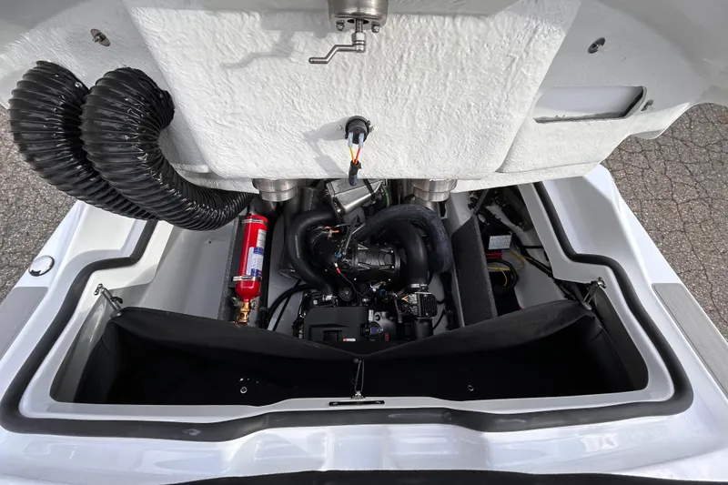 Slide: The Image of Engine compartment of 2025 Scarab 165 SE boat with visible components and fire extinguisher. - 35