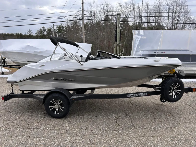 Slide: The Image of 2025 Scarab 165 SE boat on trailer, parked outdoors. - 5