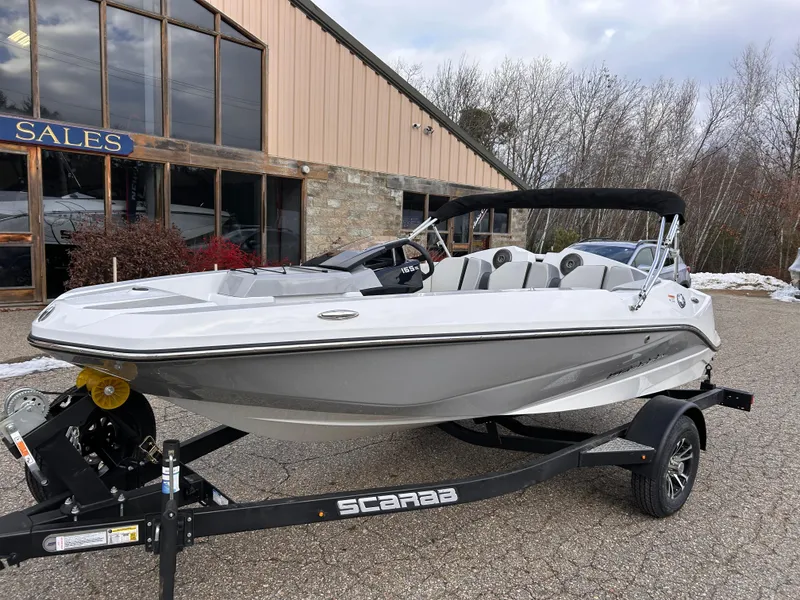 Slide: The Image of 2025 Scarab 165 SE boat on trailer outside sales building. - 7