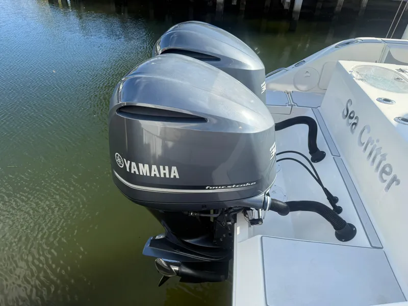 Slide: The Image of 2019 Cobia 301 Center Console with twin Yamaha outboard motors on water. - 11