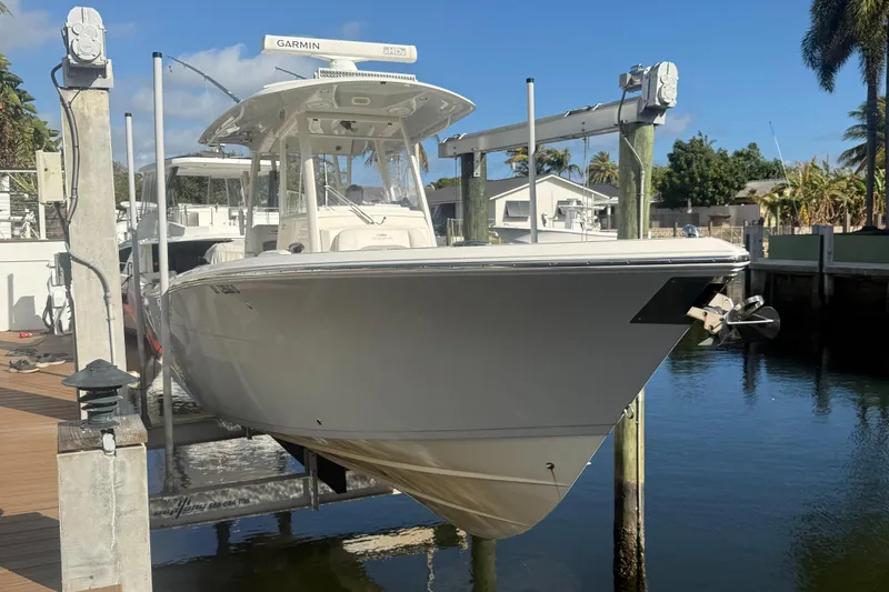 Slide: The Image of 2019 Cobia 301 Center Console boat docked in a marina. - 4