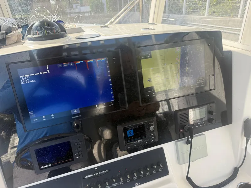 Slide: The Image of 2019 Cobia 301 Center Console dashboard with navigation and control screens. - 5