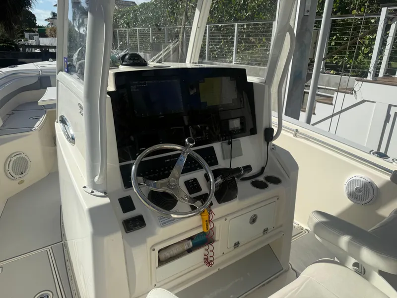 Slide: The Image of 2019 Cobia 301 Center Console boat interior with steering wheel and control panel. - 7