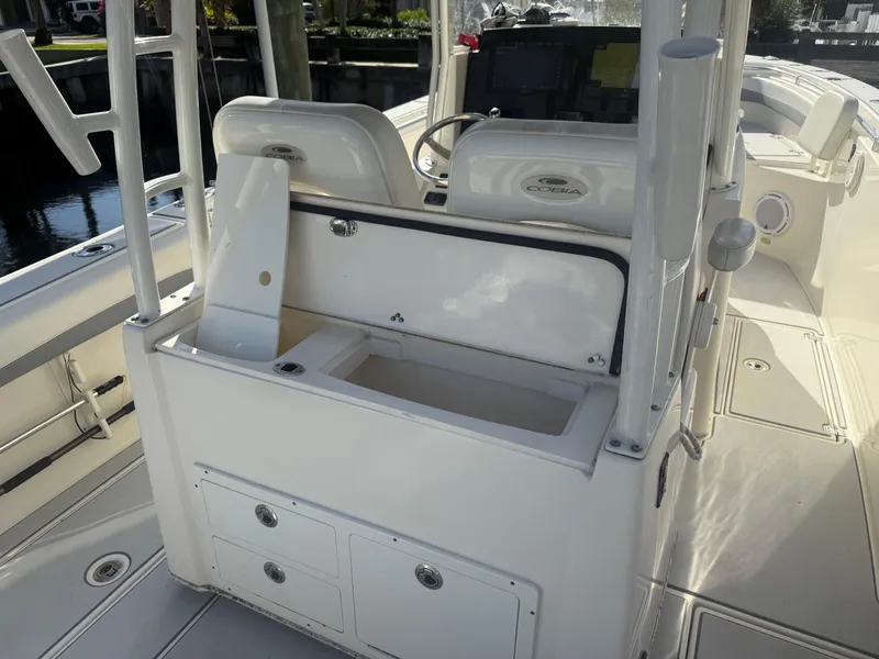 Slide: The Image of 2019 Cobia 301 Center Console boat interior with storage compartments and seating. - 8