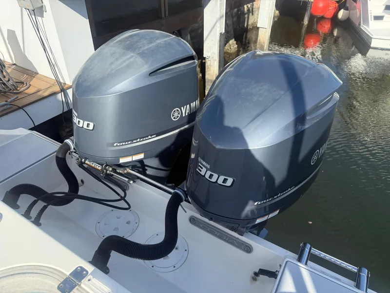 Slide: The Image of 2019 Cobia 301 Center Console with twin Yamaha 300 engines docked. - 9