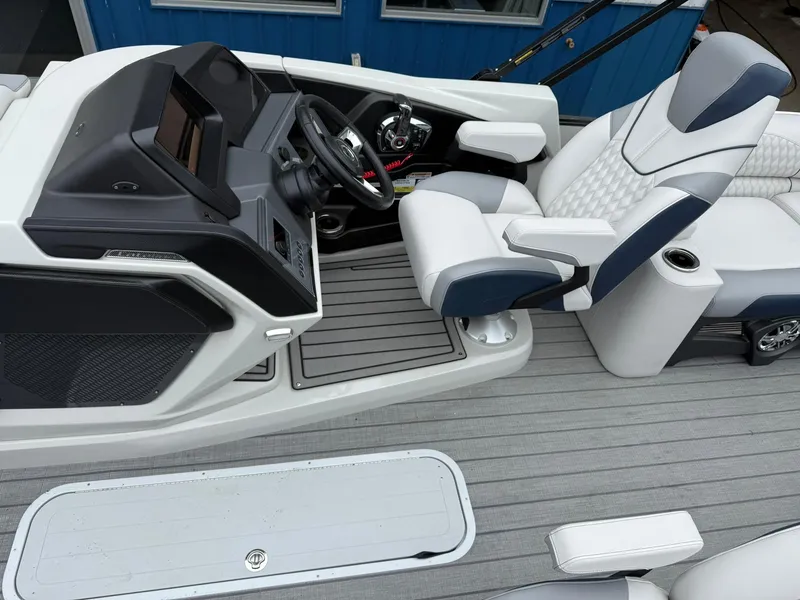 Slide: The Image of 2025 Avalon Catalina Quad Lounger Shift boat interior with modern helm and luxurious seating. - 11