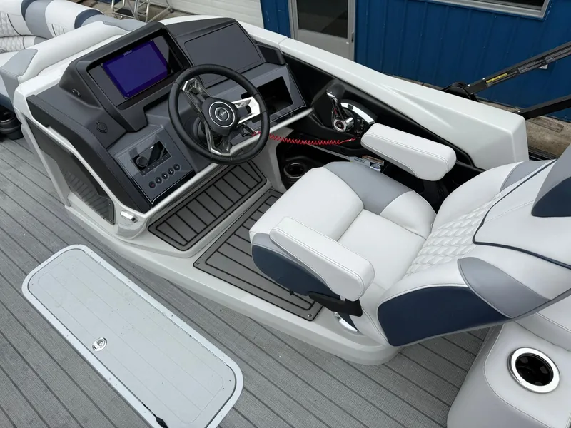 Slide: The Image of 2025 Avalon Catalina Quad Lounger Shift boat interior with modern helm and luxurious seating. - 12