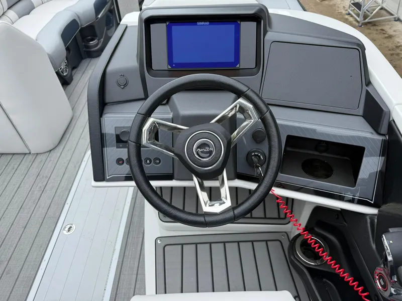 Slide: The Image of 2025 Avalon Catalina Quad Lounger Shift dashboard with steering wheel and digital display. - 13
