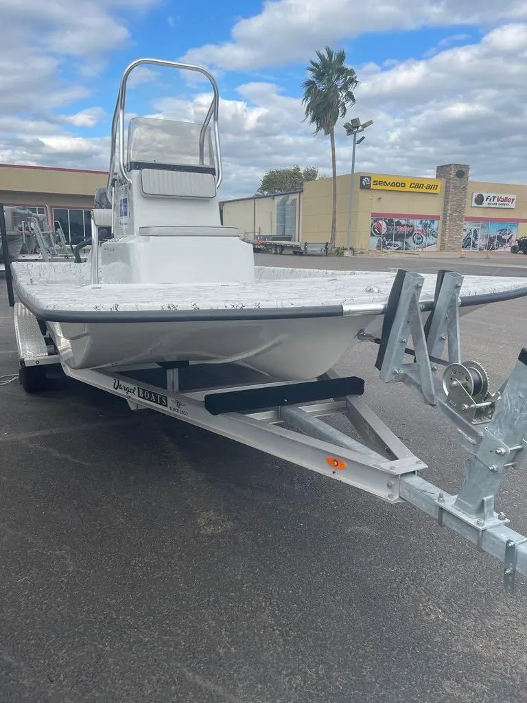 Slide: The Image of 2024 Dargel Skout 210 boat on trailer, parked outdoors under cloudy sky. - 1
