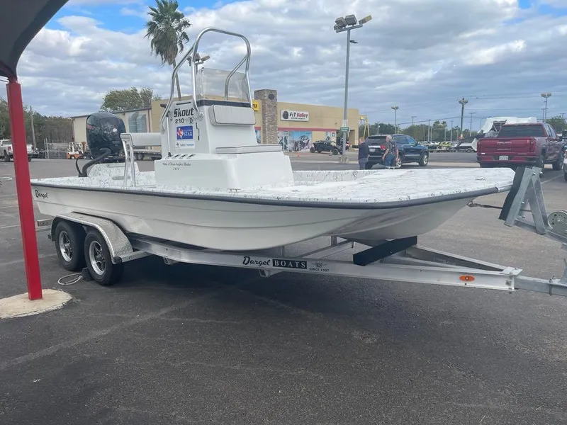 Slide: The Image of 2024 Dargel Skout 210 boat on trailer in parking lot, cloudy sky background. - 2