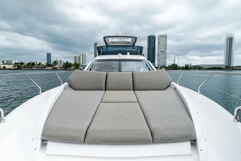 Slide: The Image of Azimut Fly 53 yacht, 2025 model, with spacious deck and city skyline backdrop. - 45