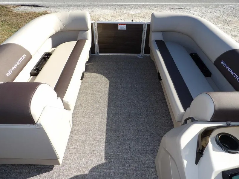 Slide: The Image of 2025 Bennington S Quad Bench 21 SSR interior with beige seating and carpeted floor. - 13