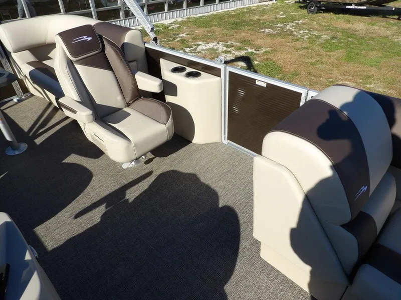 Slide: The Image of 2025 Bennington S Quad Bench 21 SSR boat interior with beige and brown seating. - 17