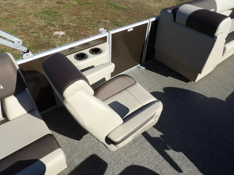 Slide: The Image of 2025 Bennington S Quad Bench 21 SSR boat interior with beige and brown seating. - 18