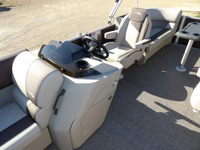 Slide: The Image of 2025 Bennington S Quad Bench 21 SSR pontoon boat interior with steering console and seating. - 19