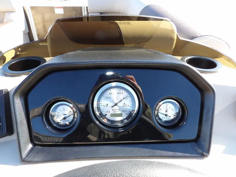 Slide: The Image of Dashboard of 2025 Bennington S Quad Bench 21 SSR with gauges and cup holders. - 22